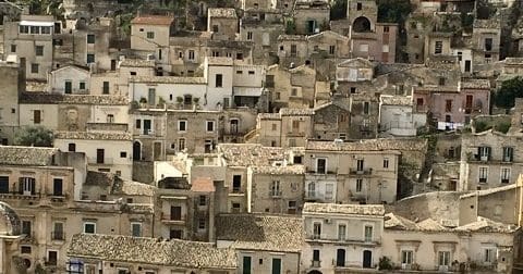 Old Sicilian houses, beige and terracotta rooves and buildings.